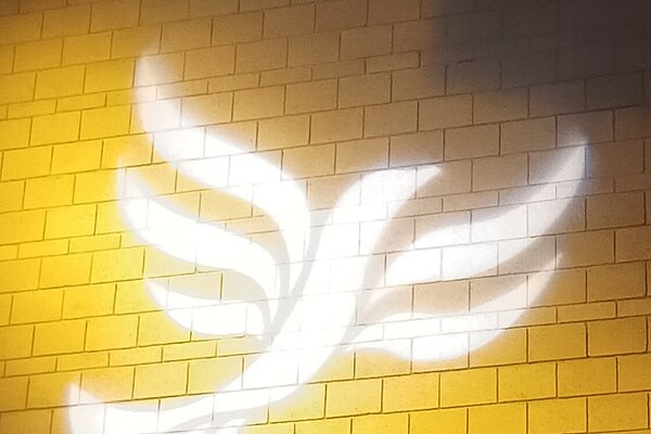 Lib Dem logo bird projected on blockwork